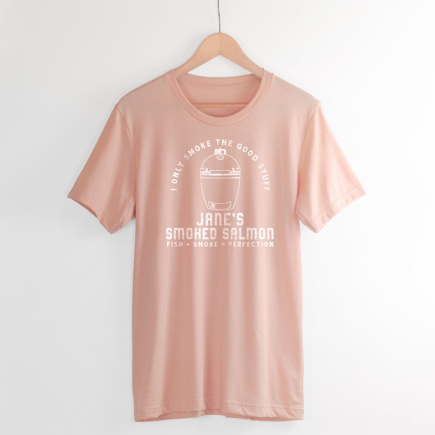 
                  
                    a personalized green egg grill inspired shirt in peach
                  
                
