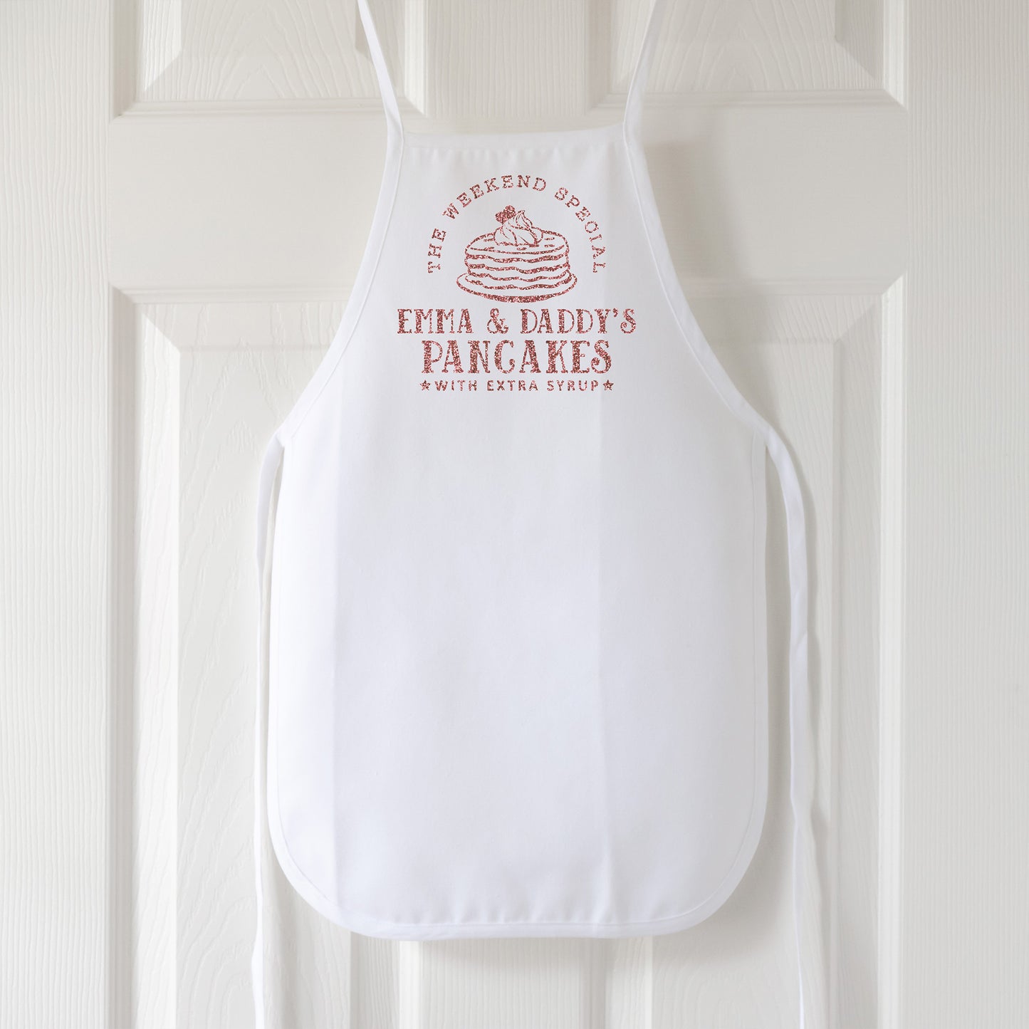 
                  
                    a toddler personalized pancake apron in white
                  
                