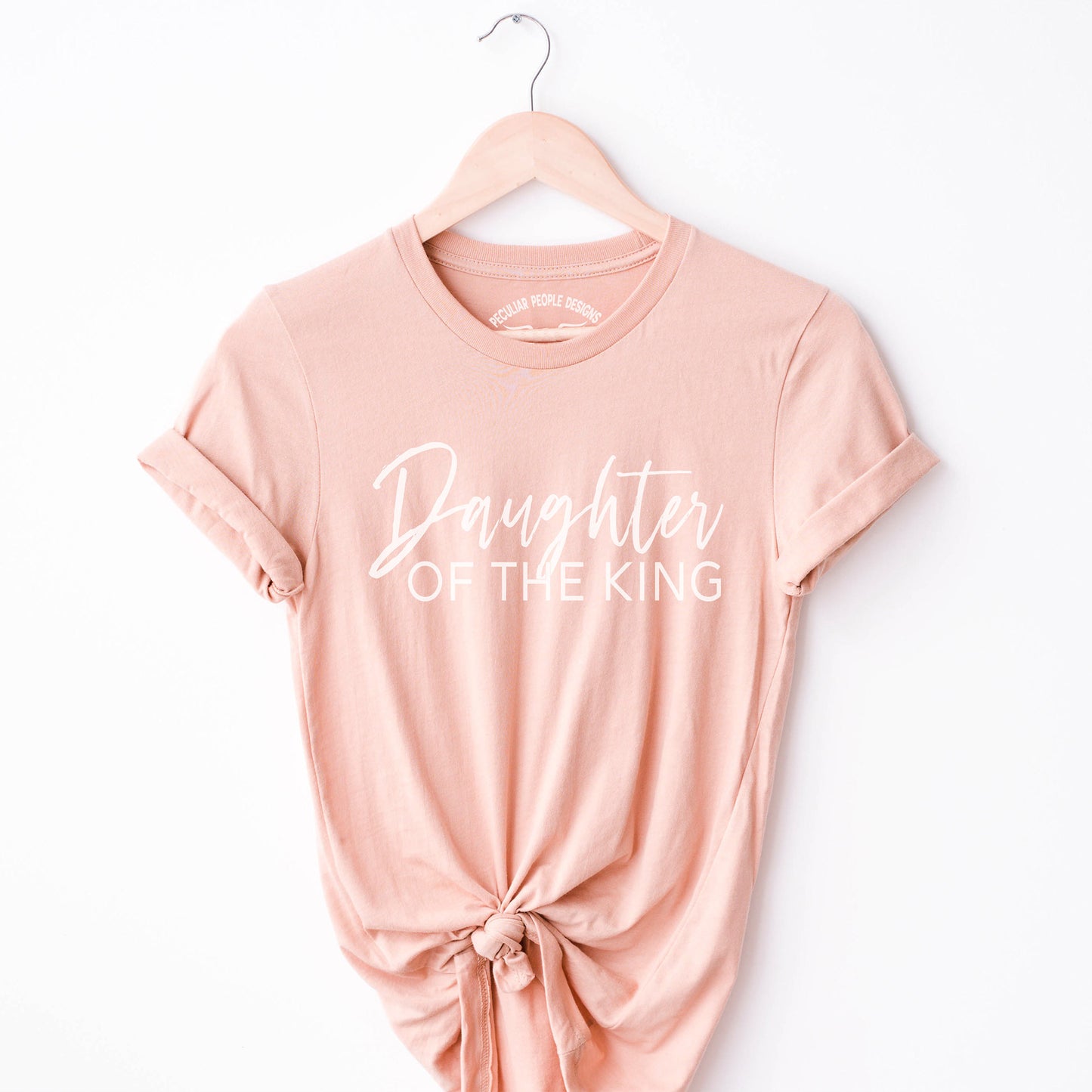 
                  
                     a Daughter of the king shirt in peach
                  
                