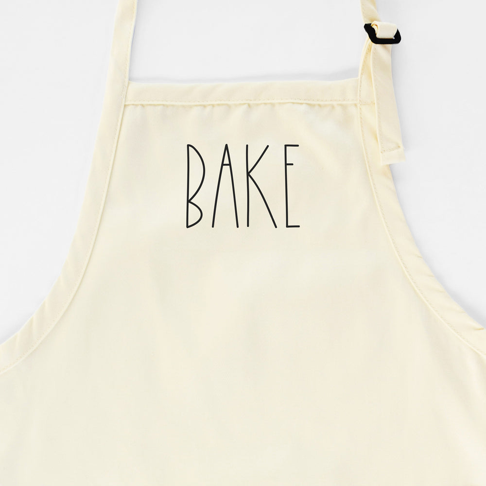 
                  
                    a Bake apron in natural
                  
                