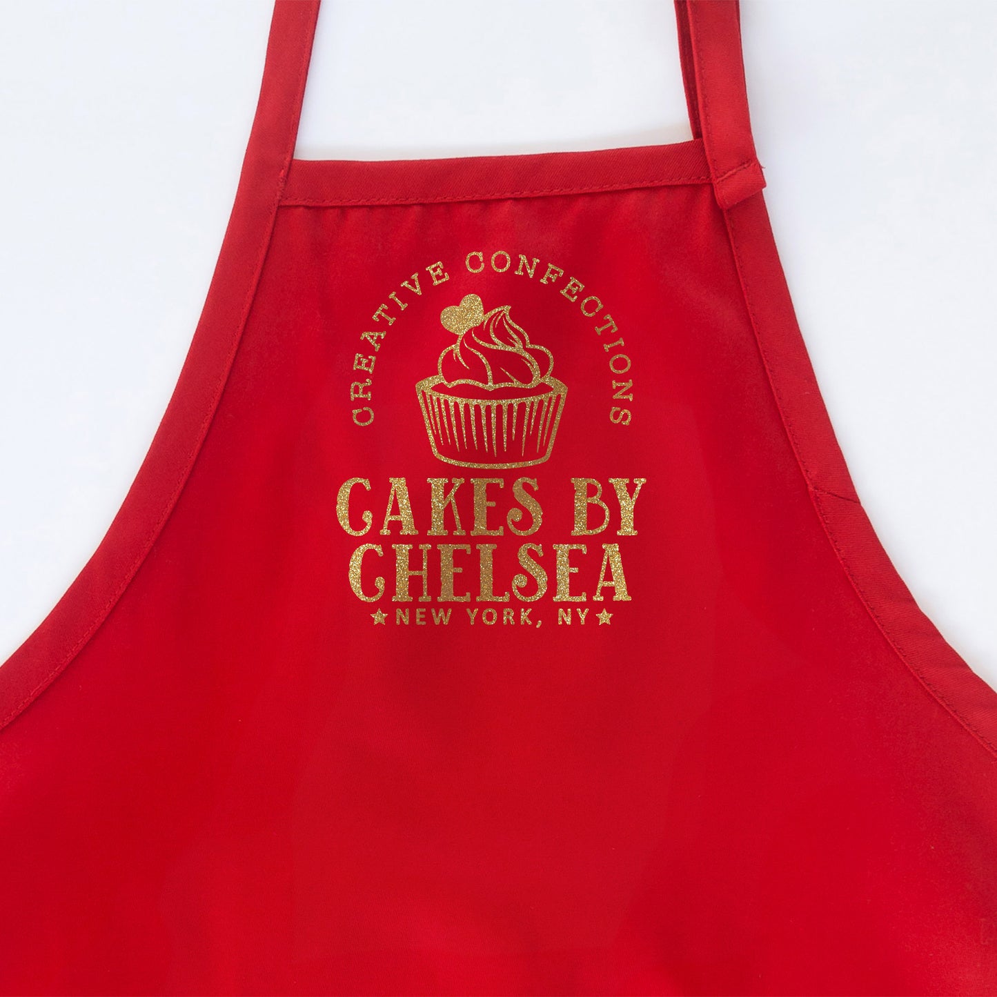 
                  
                    a personalized cupcake baking apron in red
                  
                
