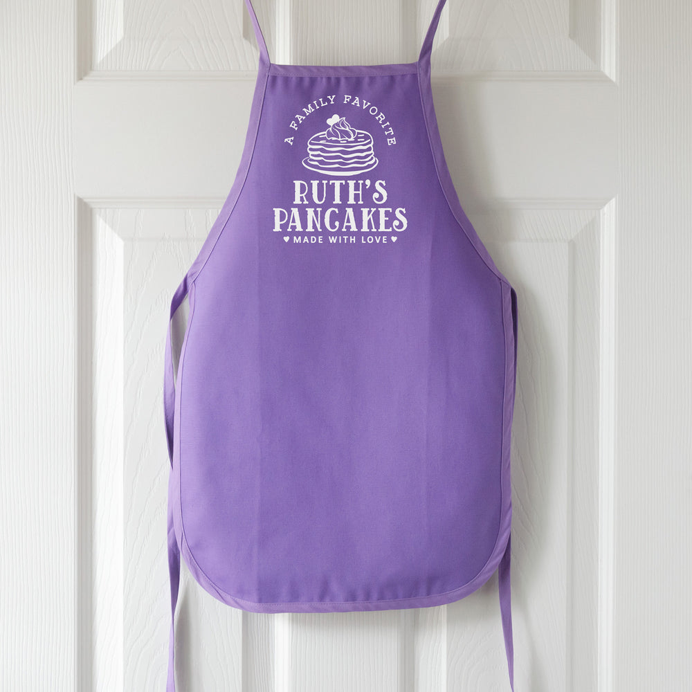 
                  
                    a toddler personalized pancake apron in purple 
                  
                