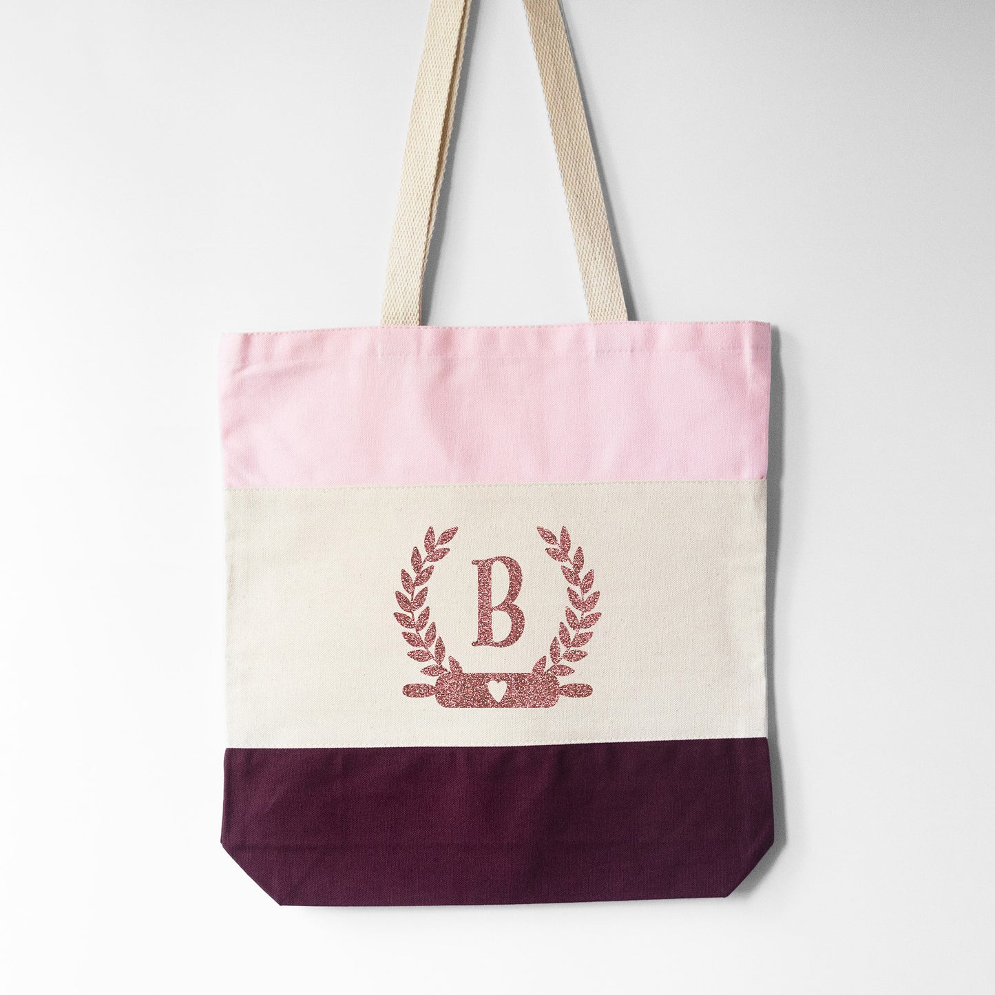 
                  
                    a monogrammed baking tote bag in pink
                  
                