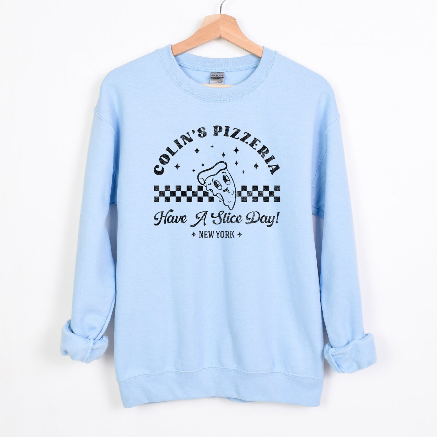 
                  
                    a personalized retro pizzeria sweatshirt in light blue
                  
                