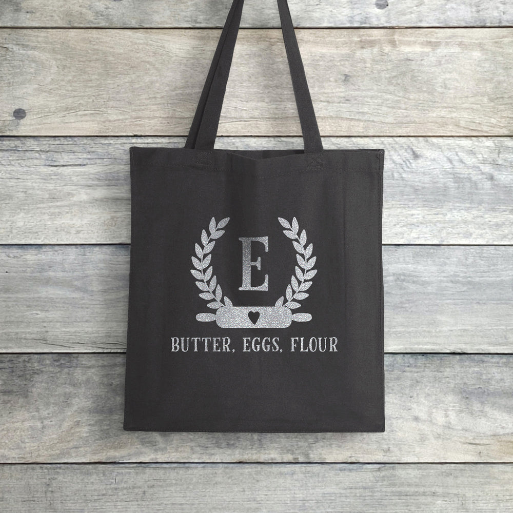 
                  
                    a personalized baking monogram tote in grey
                  
                