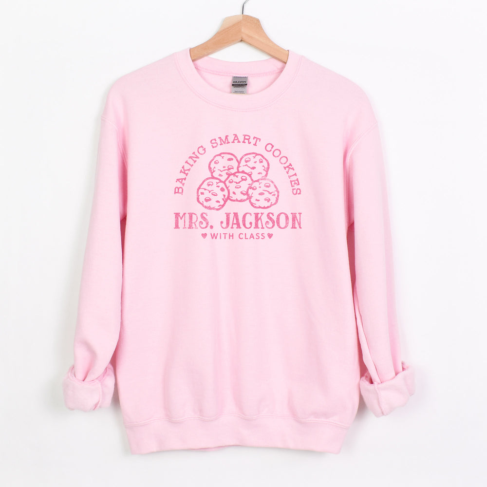 
                  
                    a personalized cookie baker sweatshirt in light pink
                  
                