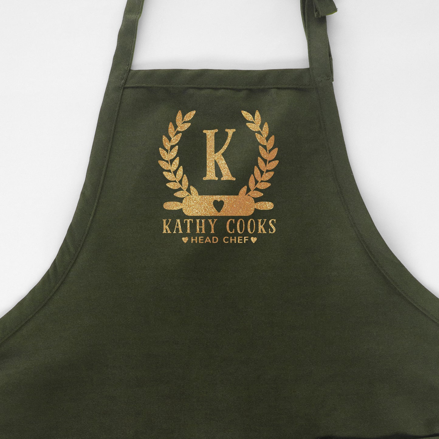
                  
                    a personalized monogrammed baking apron in green
                  
                