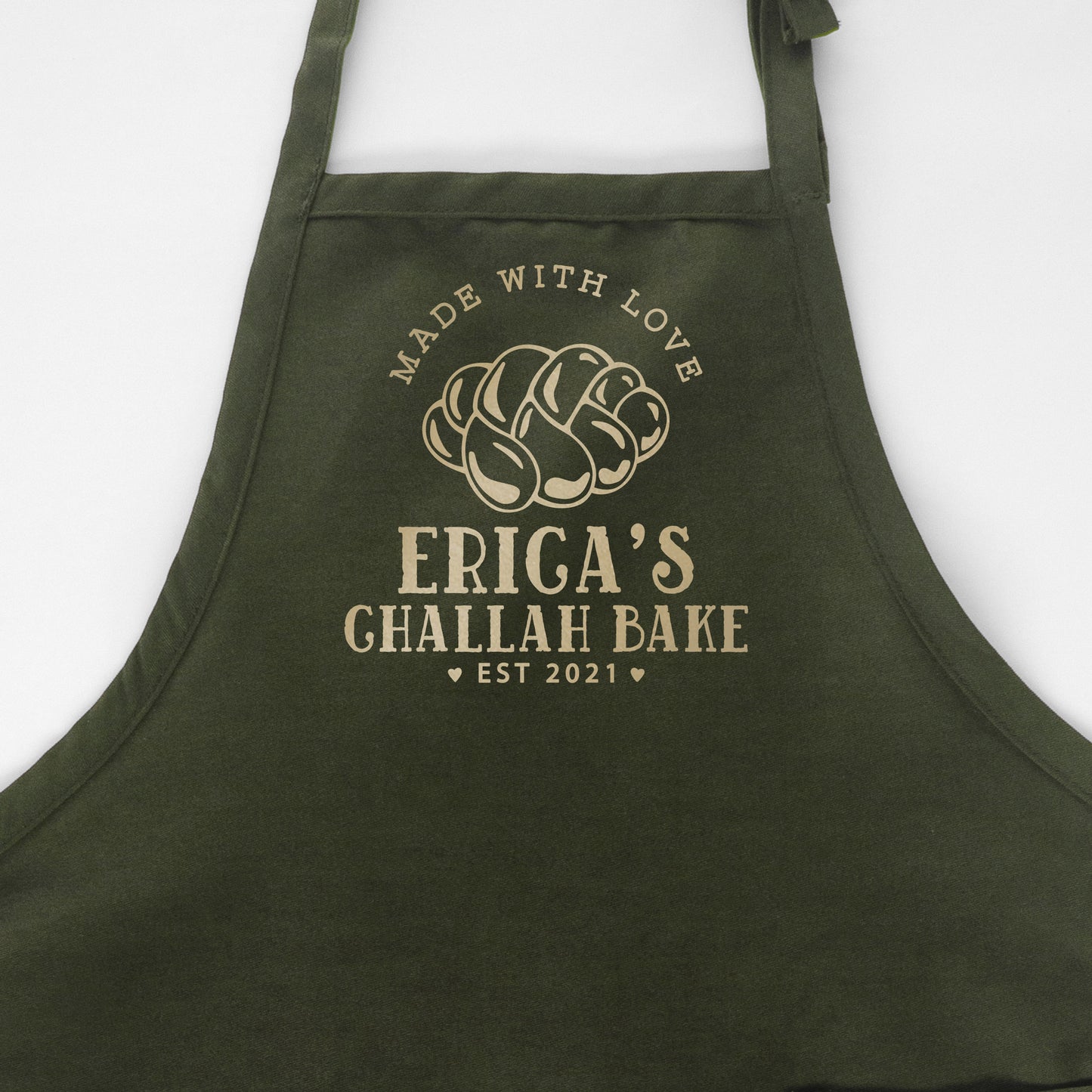 
                  
                    a personalized challah baking apron in green
                  
                