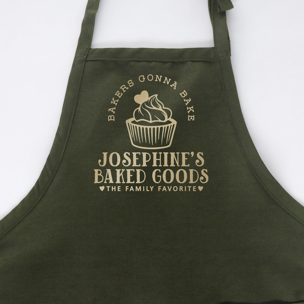 
                  
                    a personalized cupcake baking apron in green
                  
                