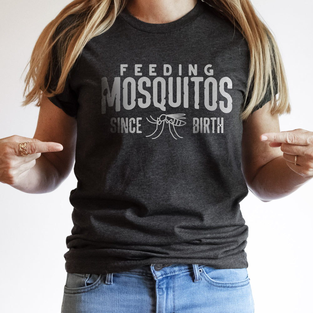 a young woman wearing Feeding mosquitos shirt in dark grey