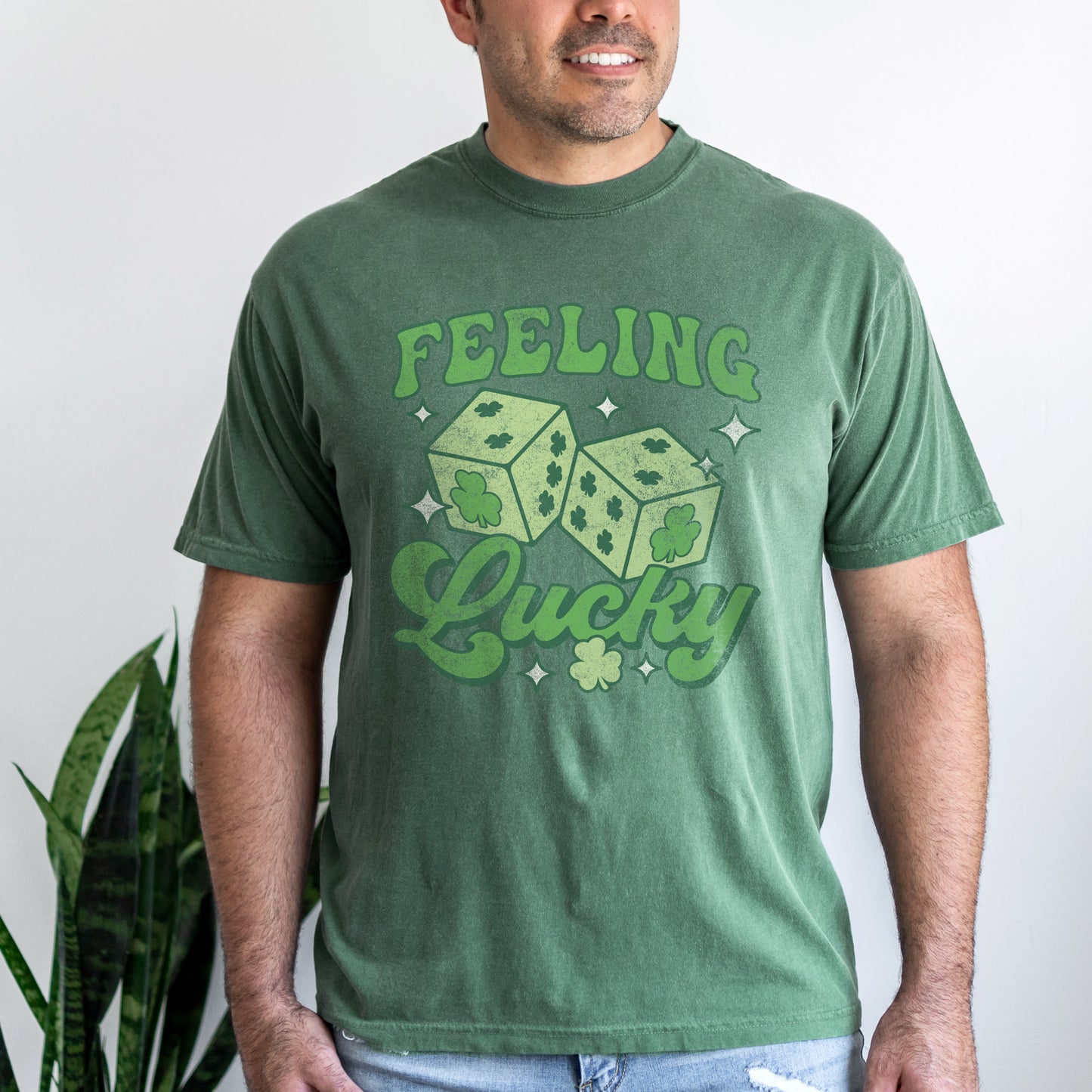 
                  
                    a smiling young man wearing a feeling lucky tee in light green
                  
                