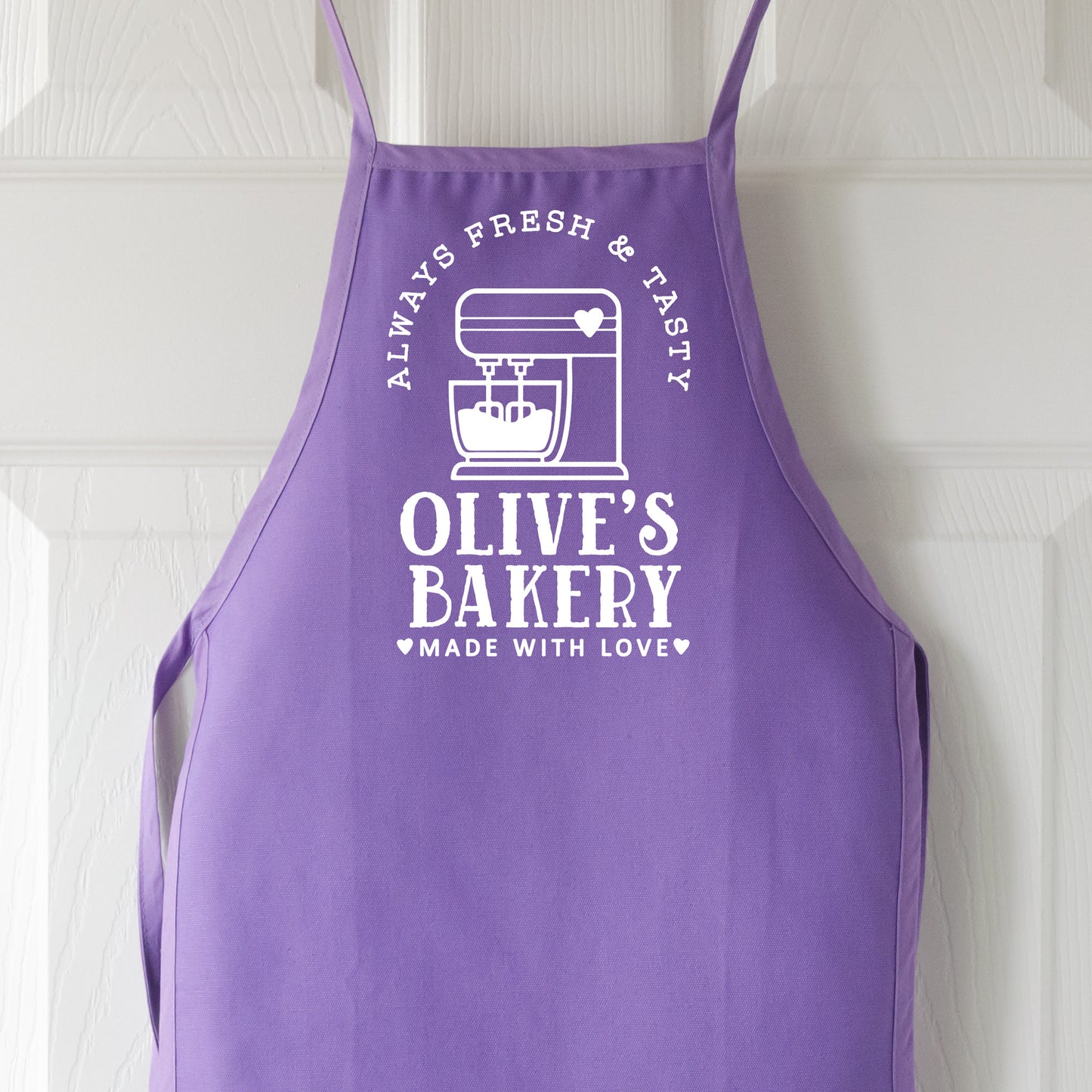 
                  
                    a kid's personalized kitchen mixer apron in purple
                  
                