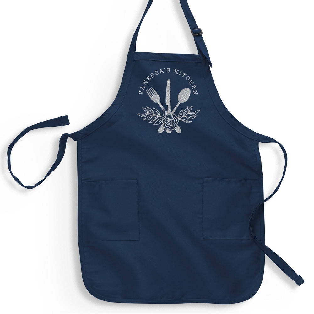 a navy apron printed with silver glitter reading 